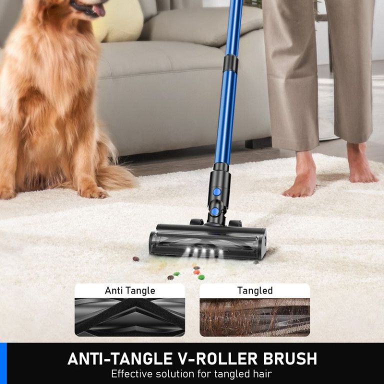 Vacuum cleaning carpet beside golden retriever