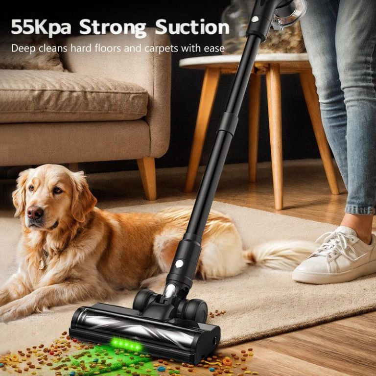 Vacuum cleaning pet food beside golden retriever