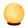 Glowing Himalayan salt lamp on wooden base