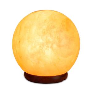 Glowing Himalayan salt lamp on wooden base