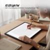 Artist using A3 LED light pad for tracing