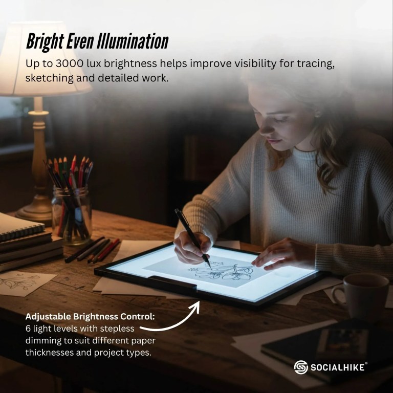 Artist using illuminated light pad for detailed tracing
