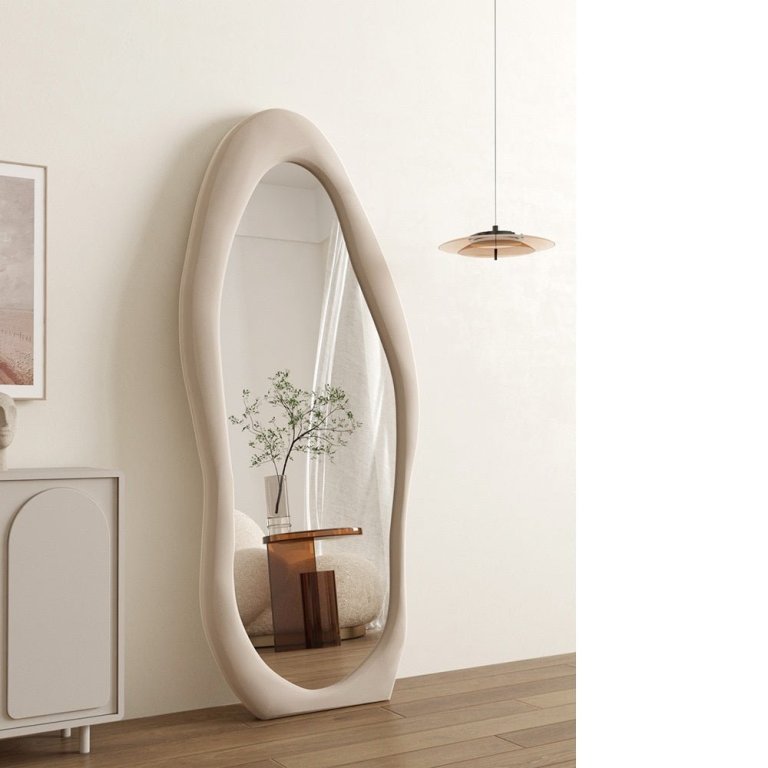 Modern sculptural floor mirror in minimalist room