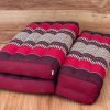 3 fold zafu meditation cushion medium size red Stacked red Thai floor cushions on wooden floor
