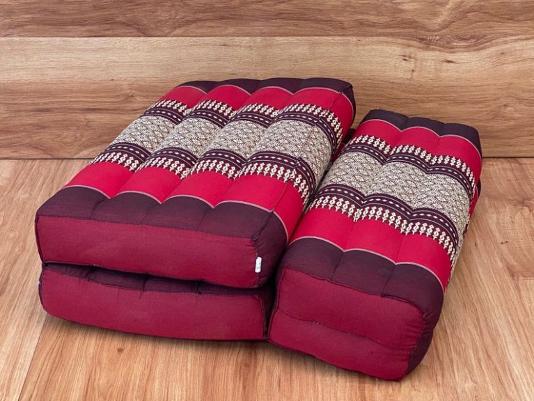 3 fold zafu meditation cushion medium size red Stacked red Thai floor cushions on wooden floor