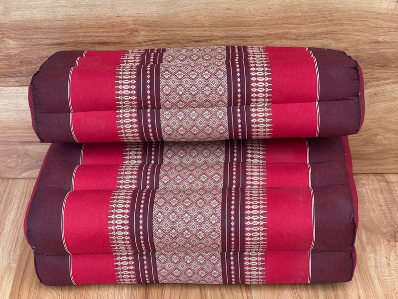 Stacked red and brown patterned floor cushions