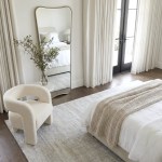 interior ave pierre full length gold frame wall mirror — classic statement Minimalist bedroom with mirror, armchair and knitted throw