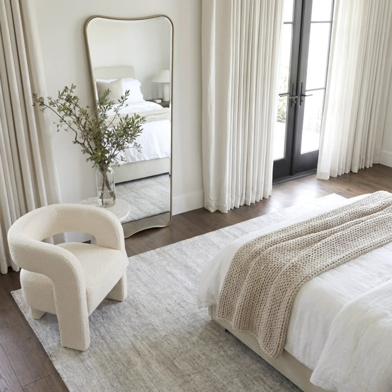 interior ave pierre full length gold frame wall mirror — classic statement Minimalist bedroom with mirror, armchair and knitted throw
