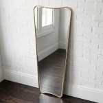 interior ave pierre full length gold frame wall mirror — classic statement Gold-framed wavy mirror against white brick wall