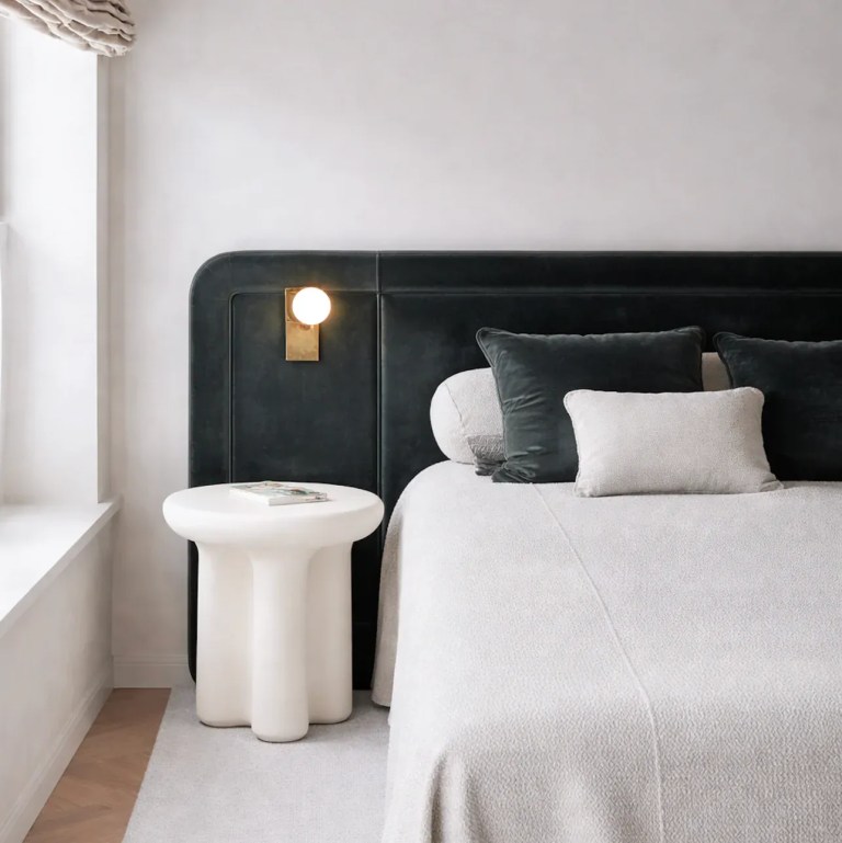 interior ave santorini stone side table ivory Modern bedroom with dark headboard and white bedding