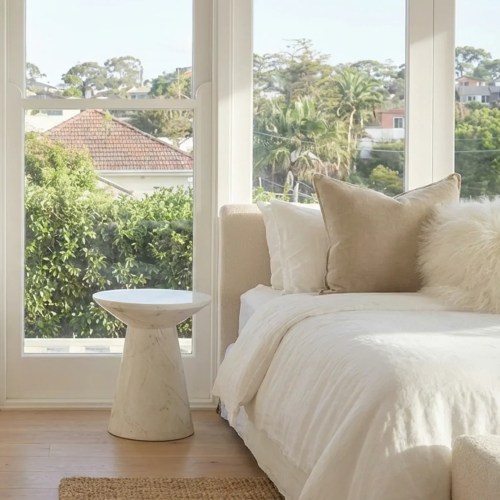 v355 ia st ven cal 00.webp Bright bedroom with large windows and garden view