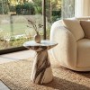 Marble side table beside cream sofa by window