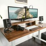 Modern dual monitor desk setup with speakers