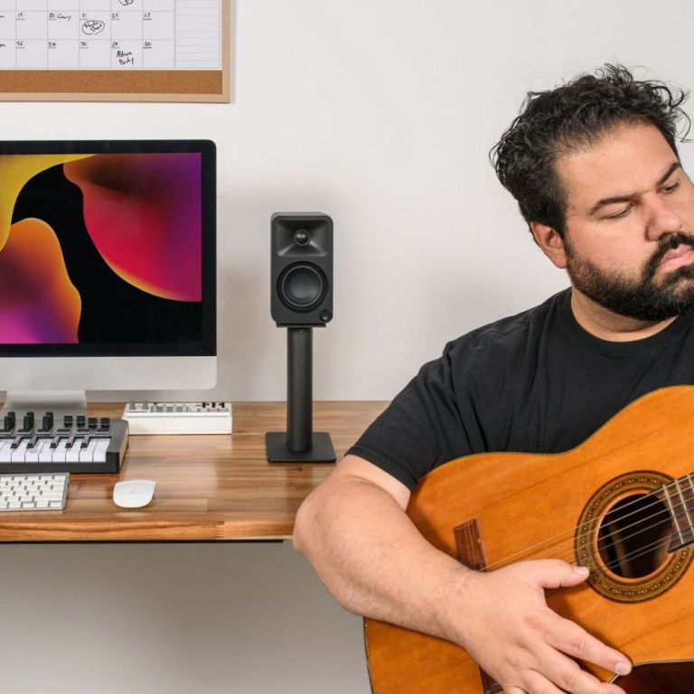 Man playing acoustic guitar in home studio