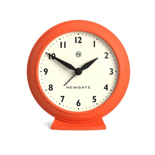 Orange Newgate analogue clock showing 10:10