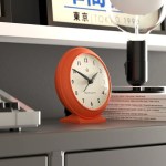 Orange retro alarm clock on modern shelf