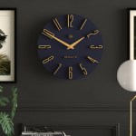 Modern navy and gold wall clock on dark wall