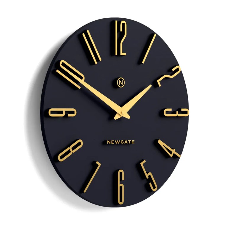 Black oval wall clock with gold numerals
