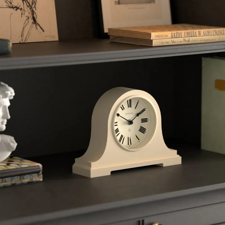 newgate broadway mantel clock vanilla cream White mantel clock on dark wooden shelf