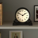 Black mantel clock on shelf showing ten past ten