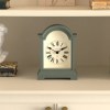 Classic mantel clock with Roman numerals on shelf
