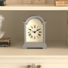 Classic mantel clock on white shelf