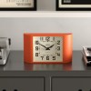 newgate mini metro mantel clock pumpkin orange Retro orange desk clock on grey cabinet
