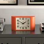 Retro orange desk clock on grey cabinet