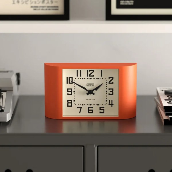 newgate mini metro mantel clock pumpkin orange Retro orange desk clock on grey cabinet