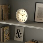 newgate q mantel clock clock grey White analog clock on shelf with books