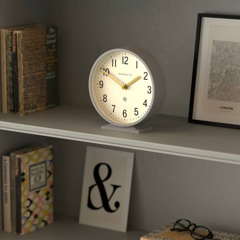 newgate q mantel clock clock grey White analog clock on shelf with books