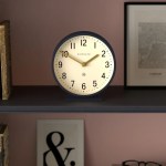 Round Newgate clock on shelf at 10:10