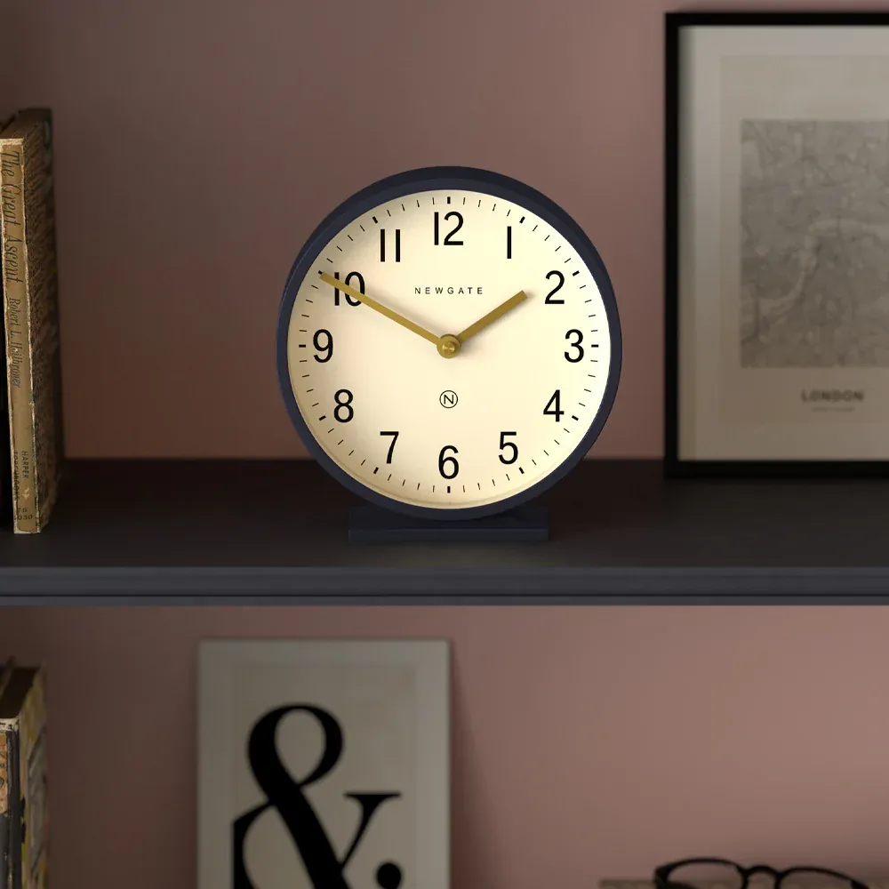 Round Newgate clock on shelf at 10:10
