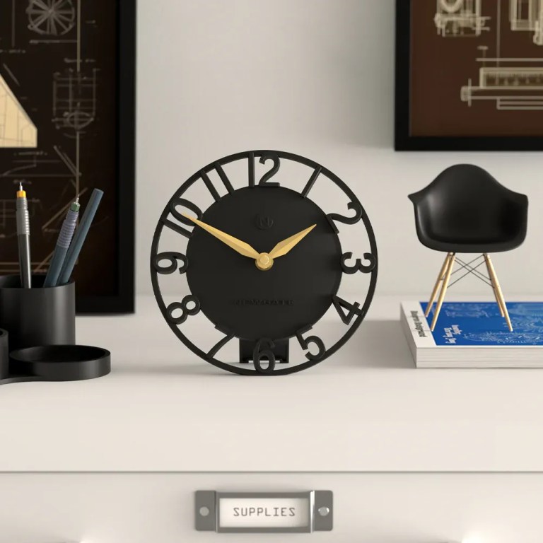 Modern black desk clock with gold hands