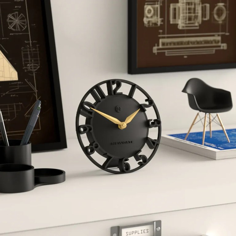 Modern black desk clock with gold hands
