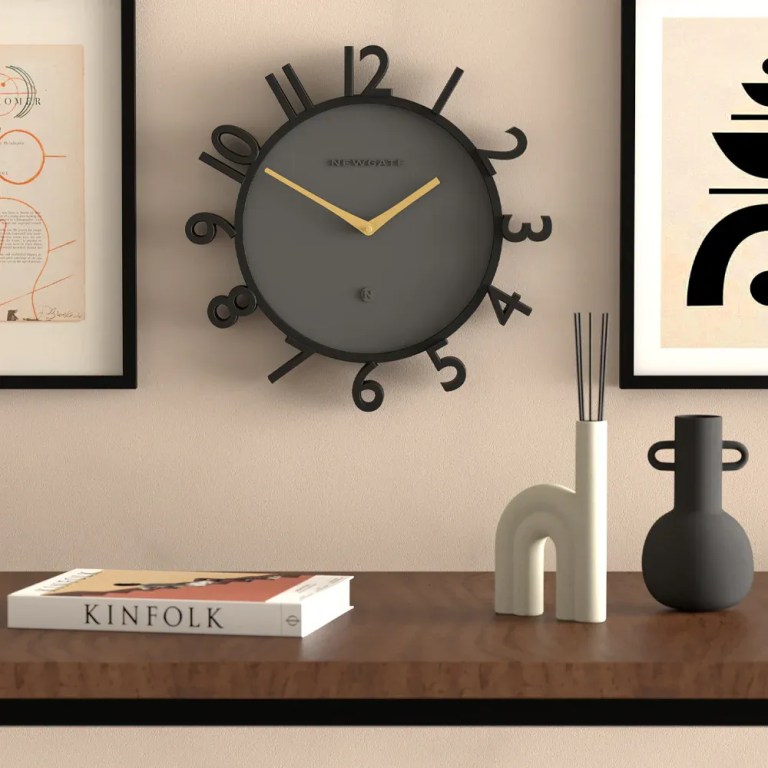 newgate monorail wall clock black Modern black wall clock above styled shelf