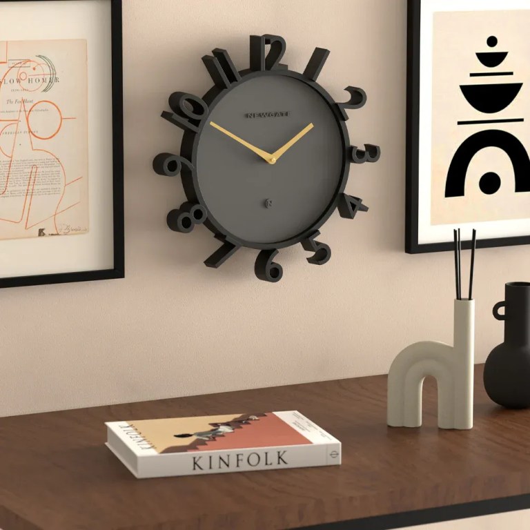 newgate monorail wall clock black Modern black wall clock above wooden console table