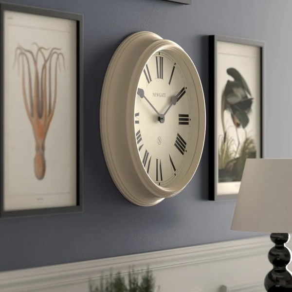 newgate notting hill wall clock vanilla cream Cream wall clock with Roman numerals on blue wall