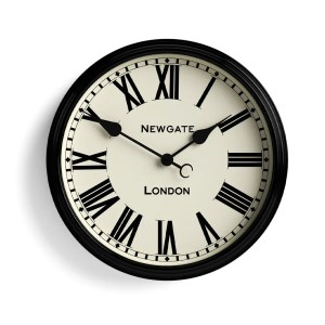 Black Roman numeral wall clock showing ten past ten