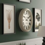 Classic wall clock between framed artworks