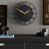 Modern black wall clock with gold hands