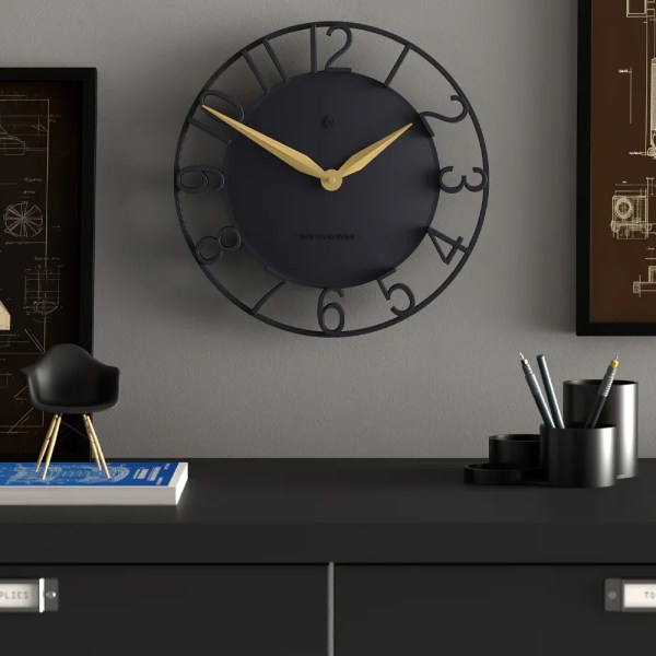 Modern black wall clock with gold hands