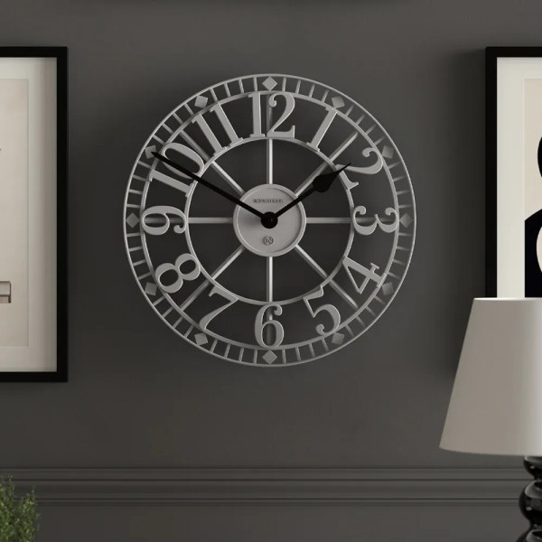 Large decorative wall clock on grey wall