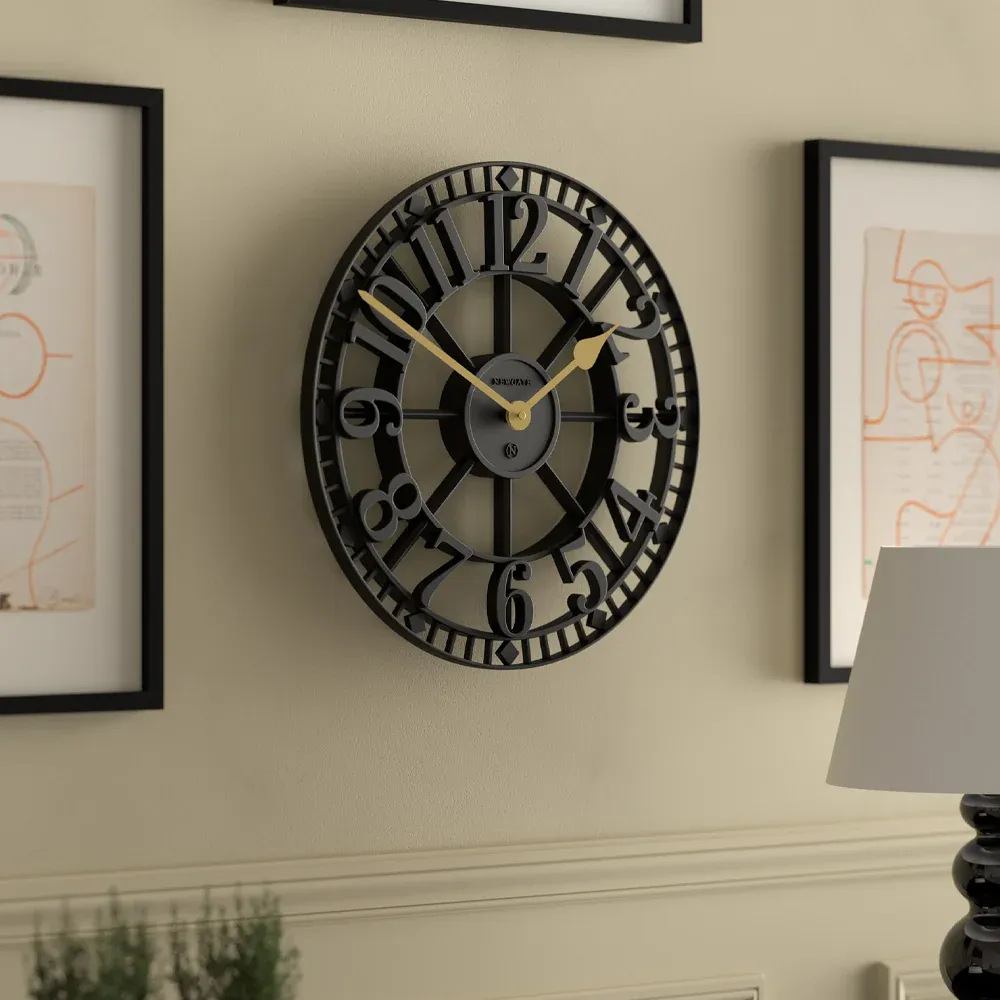 Black vintage wall clock with Roman numerals