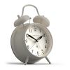 Cream twin-bell alarm clock on white background