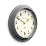 Close-up of grey wall clock with gold hands