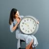newgate westhampton clock posh grey Woman holding large wall clock indoors