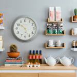 Minimalist kitchen wall with clock and wooden shelves