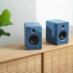 victrola tempo bookshelf speakers blue Two blue bookshelf speakers on wooden cabinet