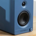 victrola tempo bookshelf speakers blue Blue Victrola bookshelf speaker on wooden table